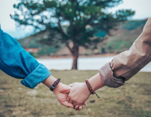 Couple holding hands - Strengthening relationships through couple counselling in Surrey, Godalming, and Headley.